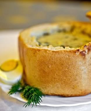 Żurek (soup made from fermented rye flour) in a loaf of bread